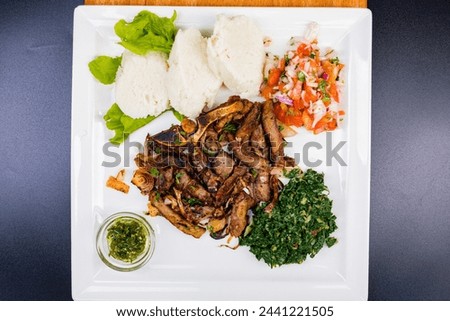 Kenyan cuisine includes ugali, chapati, githeri, goat, Nyama Choma, stews, samosas and sukuma wiki. Ugali is a maize meal, similar to American grits, which is simply cooked in boiling water until it h
