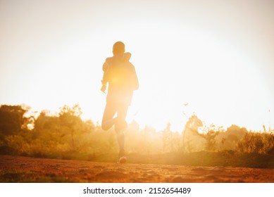 A Kenyan runner runs at sunrise in the city of Iten in Kenya. The marathoner prepares for the race in the morning. Training sports running photo - Shutterstock ID 2152654489