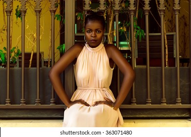 Kenyan Woman Sitting Near Fence