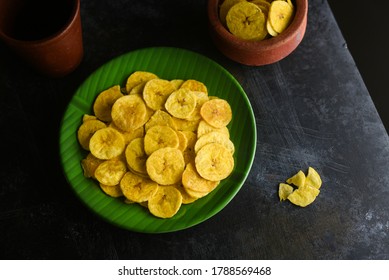 Kerala Banana chips or Kaya Varuthathu fried snacks on black background popular in Kerala South India Tamil Nadu, Top view of Indian tea time food fried in coconut oil.