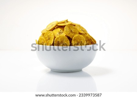 Kerala chips or Banana chips, cult snack item of Kerala,arranged in a white bowl Isolated image with white background