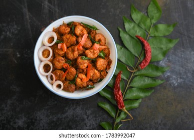 Kerala Fish Curry Prawns, Chemmeen Roast Shrimp Fry Spicy Prawns Masala In Banana Leaf Plate On Dark Black Background In South India. Top View Popular Indian Non Veg Food Side Dish For Rice, Chapati