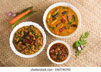 Kerala food for Onam festival special curry Sambar , Erissery , puli inji Onam sadya , sadhya palm mat background. popular Sri Lankan food . South Indian spicy vegetable curry vegan vegetarian dish