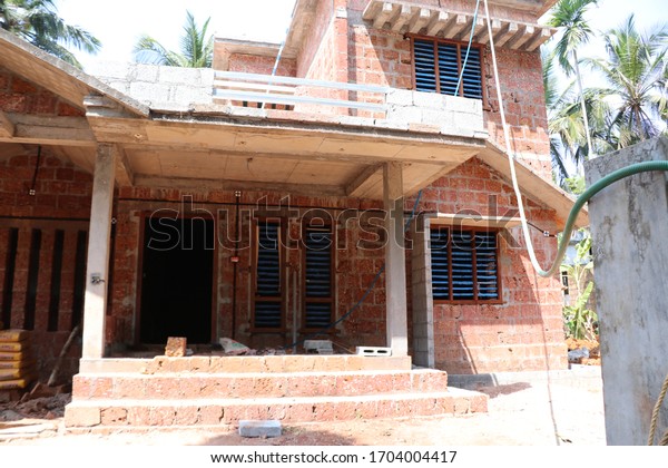 Kerala home construction structure site, home building progress with natural bricks chenkallu and concrete