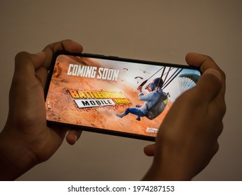 Kerala , India - 16 May 2021 : Photo of a player hand holding smartphone with Battlegrounds mobile India trailer previously known as playerunknown's battlegrounds also known as PUBG India.