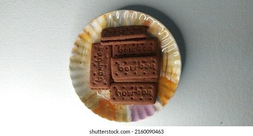 Kerala, India 24-May-2022 Typical Bourbon Chocolate Cream Filled Dunking Biscuit Or Cookie On Plate. Isolated On Plain White Table Background With Copy Space. Selective Focus Clouse Up Macro Top View.