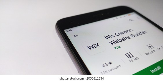 Kerala, India 27-Aug-2021 Wix owner website builder and web development app on google play store opened in mobile phone device on a white table background surface with copy space. closeup top view.
