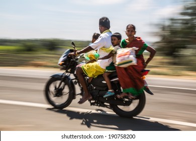 KERALA, INDIA - FEBRUARY 17: Family Riding On A Bike (blurred Motion). Motorbike Is The Most Favorite Vehicle And Most Affordable For India.