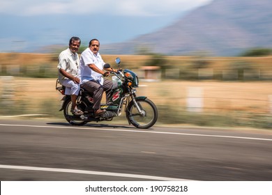 KERALA, INDIA - FEBRUARY 17: Two Men Riding On A Bike (blurred Motion). Motorbike Is The Most Favorite Vehicle And Most Affordable For India.