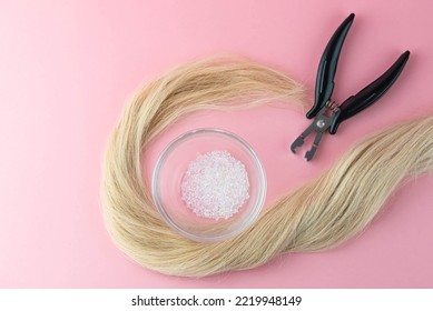 Keratin Glue Pellets Granules Beads For Nail Tip Hair Extensions Transparent Hot Melt Grain With Pliers Or Forceps Tools For Forming Keratin Capsules To Bond Extension To The Natural Blond Human Hair.