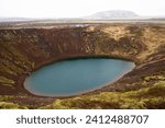 Kerid (Kerið) volcanic crater lake in the Grimsnes area, South Iceland with volcanic soil covered with moss.