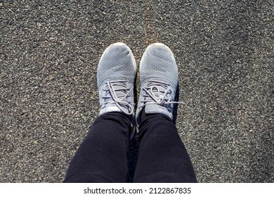 Kernersville NC United States February 9 2022 A Woman With Black Leggings And A Pair Of Gray Women Tennis Shoes With On A Concrete Background 