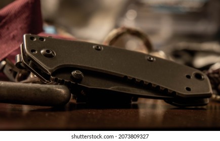 A Kershaw knife rests among a pile of equipment.