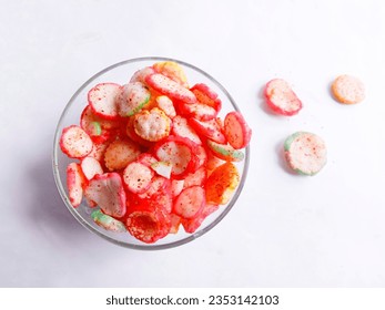 Kerupuk seblak. dry spicy seasoning crackers in a glass bowl on white background. spicy snack. Spicy colorful small crackers for daily snacks. top view - Powered by Shutterstock