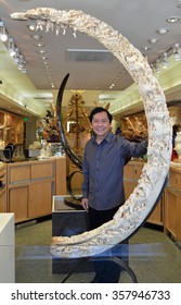 KETCHIKAN, ALASKA - JUNE, 2015 - Master Sculpture Eddie Lee poses with his woolly mammoth carving.