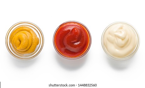 ketchup, mustard, mayonnaise in glass bowls on a white background. Traditional fast food and barbecue sauces.