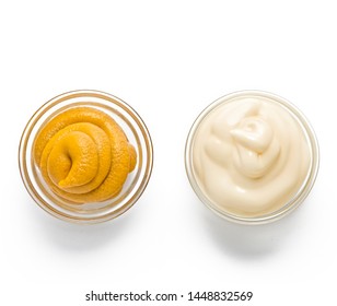 ketchup, mustard, mayonnaise in glass bowls on a white background. Traditional fast food and barbecue sauces.