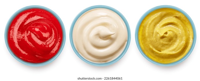 Ketchup, mustard and mayonnaise sauces on ceramic blue bowl isolated on a white background. File contains clipping path.