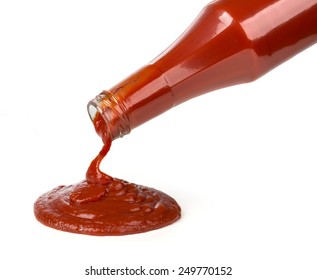 ketchup pouring out of bottle on white background