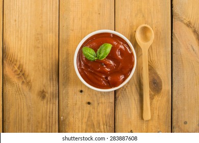 Ketchup In A White Bowl On Wooden Table