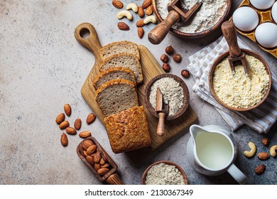 Keto bread cooking. Different types of nut flour - almond, hazelnut, cashew and baking ingredients, dark background, top view. Gluten free concept. - Powered by Shutterstock