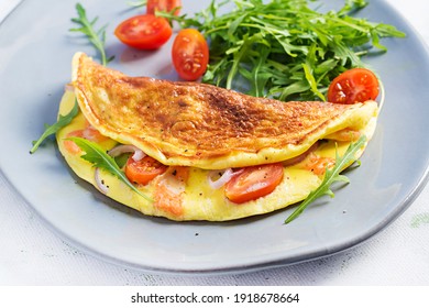 Keto breakfast. Omelette with cheese, tomatoes and avocado on light table. Italian frittata. Keto, ketogenic lunch.