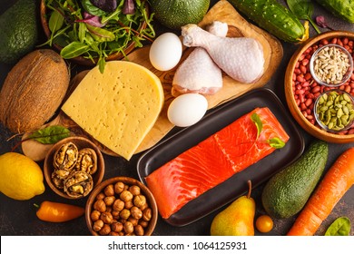 Keto diet concept. Ketogenic diet food. Balanced low-carb food background. Vegetables, fish, meat, cheese, nuts on a dark background.