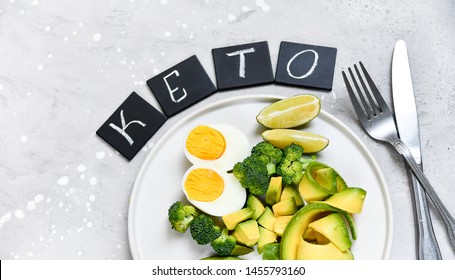 keto diet food : avocado and broccoli, with eggs and spinach and lime. on white craft plate. healthy lunch. ketogenic diet 