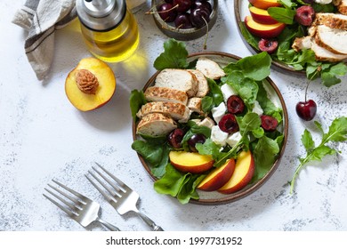 Keto Diet Lunch. Healthy Diet Salad With Arugula, Grilled Turkey, Peach, Cherry, Feta And Vinaigrette Dressing On A Stone Tabletop.