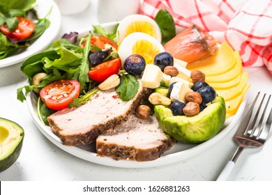 Keto Diet Plate. Low Carb Dish, Healthy Nutrition. Baked Meat, Eggs, Avocado, Salad Leaves, Cheese And Fish.