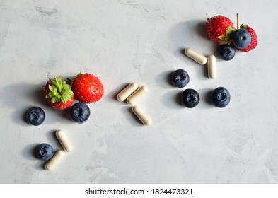 Keto Fresh Organic Strawberry And Blackberry  Next To Enzyme Supplement Pill For Digestive Health Safe On A Ketogenic Diet