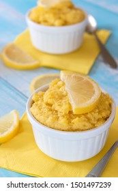 Keto Lemon Mug Cake With Almond Flour In White Mug And Blue Table