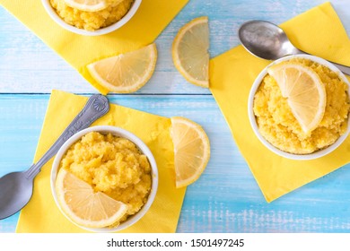 Keto Lemon Mug Cake With Almond Flour In White Mug And Blue Table