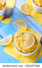 Keto Lemon Mug Cake With Almond Flour In White Mug And Blue Table