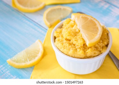 Keto Lemon Mug Cake With Almond Flour In White Mug And Blue Table