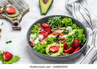 Ketogenic diet food, chicken fillet, quinoa, avocado, avocado, feta cheese, quail eggs, strawberries nuts and lettuce. healthy meal concept, top view,