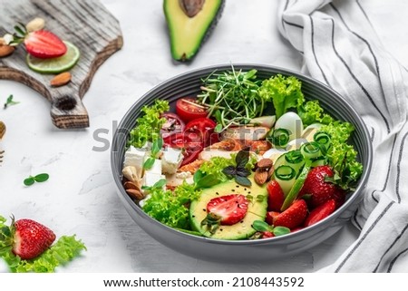 Ketogenic diet food, chicken fillet, quinoa, avocado, avocado, feta cheese, quail eggs, strawberries nuts and lettuce. healthy meal concept, top view,