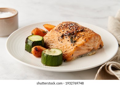 Ketogenic Dinner With Fish. Fillet Of Salmon With Vegetables On White Plate - Zucchini, Carrots. Healthy Diet Food, Keto Diet, Mediterranean Cuisine. Side View, Close Up