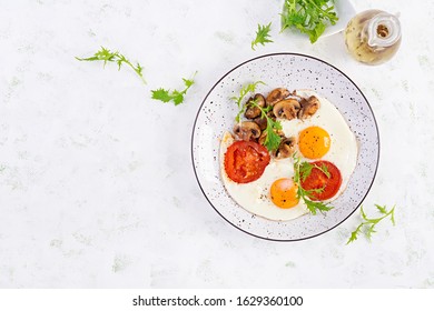 Ketogenic Food. Fried Egg, Mushrooms And Sliced Tomatoes. Keto, Paleo Breakfast. Top View, Overhead, Copy Space