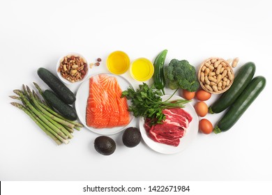 Ketogenic, keto diet, including vegetables, meat and fish, nuts and oil isolated on white background, horizontal