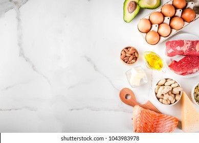 Ketogenic low carbs diet concept. Healthy balanced food with high content of healthy fats. Diet for the heart and blood vessels. Organic food ingredients, white marble background, copy space top view