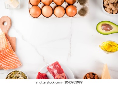 Ketogenic low carbs diet concept. Healthy balanced food with high content of healthy fats. Diet for the heart and blood vessels. Organic food ingredients, white marble background, copy space top view