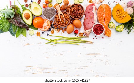 Ketogenic low carbs diet concept. Ingredients for healthy foods selection on white wooden background. Balanced healthy ingredients of unsaturated fats for the heart and blood vessels.