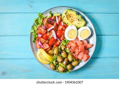 Ketogenic, Paleo Diet Lunch Bowl With Salted Salmon Fish, Lemon, Avocado, Olives, Boiled Egg, Tomato, Green Lettuce Salad, Healthy Food Trend, Top View