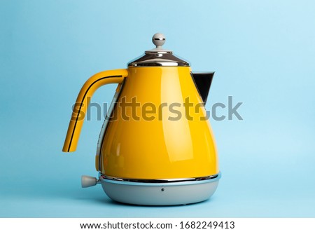 Kettle Background. Electric vintage retro kettle on a colored blue background. Lifestyle and design concept.