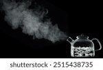 A kettle boiling water in it isolated on black background,smoke coming out of it.