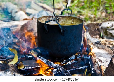 Kettle Of Boiling Water Over A Campfire On A Nature Hike