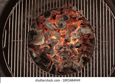 Kettle Grill Pit With Flaming Charcoal. Top View Of BBQ Hot Kettle Grill With Stainless Steel Grid, Isolated Background, Overhead View. Barbecue Kettle Grill On Backyard Ready Grilling Cookout Food.