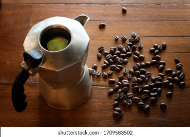 The Kettle, Hot Water And Coffee Beans Are Placed On The Wooden Floor.