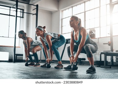 Kettlebell, group and women with fitness, exercise and progress with wellness, balance and workout goal. Female athletes, friends and girls with gym equipment, performance and sports with challenge - Powered by Shutterstock